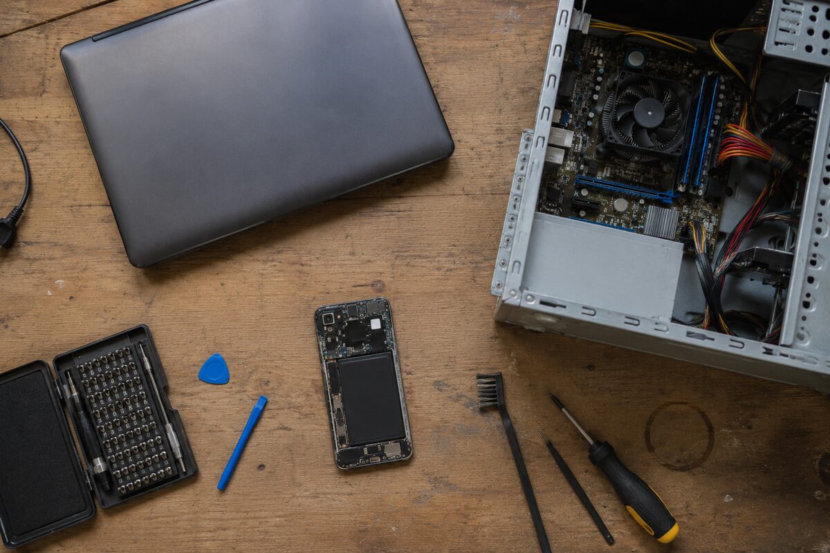 Close view of tiny board parts being repaired under a magnifying lens